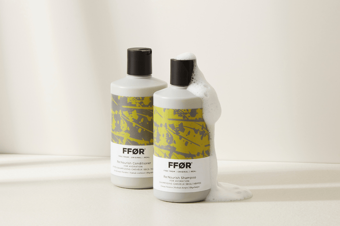 FFOR hair Re:Nourish Shampoo and Conditioner bottles with suds running down them