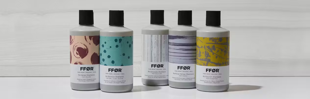 FFOR shampoo bottles sitting in a row with grey background